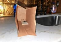 To avoid handling caught mice, place the trap inside a paper lunch bag.