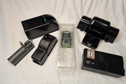 Six versions of covered mouse traps.