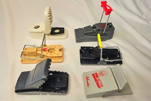 Six different reusable plastic mouse snap traps.